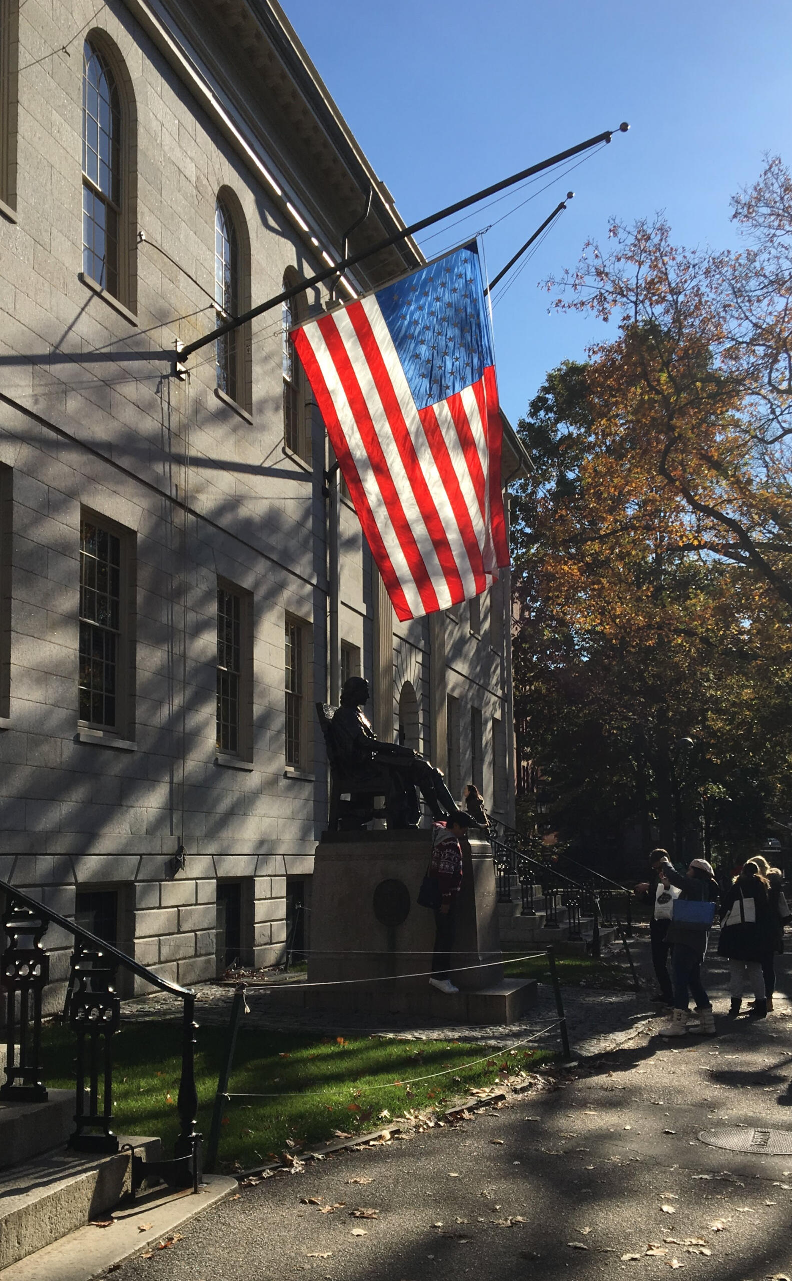 John Harvard Statue with American Flag John Harvard Statue with American Flag. Photo by Ivy-League tutor based in South Florida!